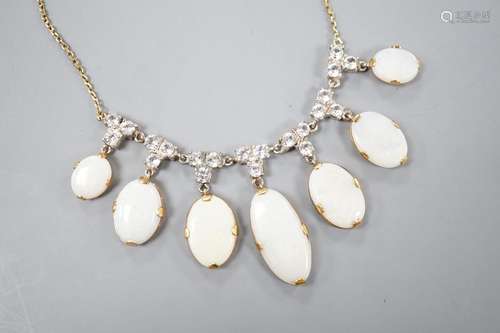 A yellow metal, graduated seven stone oval white opal and pa...