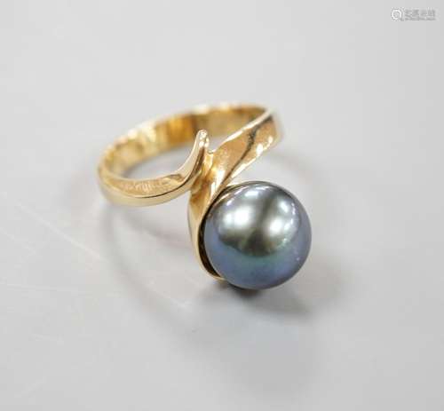 A modern 14k yellow metal and Tahitian pearl set ring, size ...