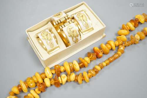 An amber bead necklace, gross 72 grams and a costume bracele...