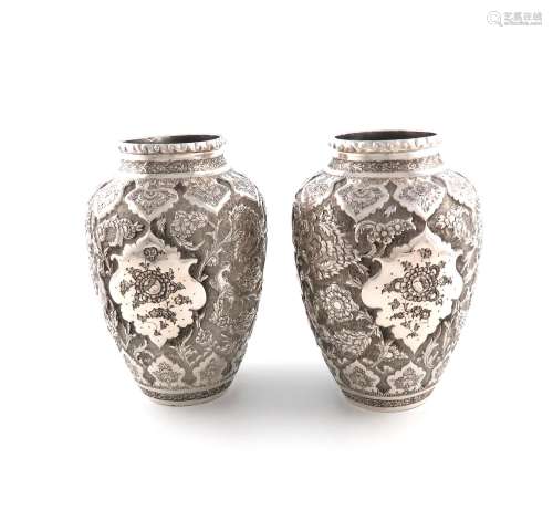 A pair of Persian silver vases, tapering circular form, chas...