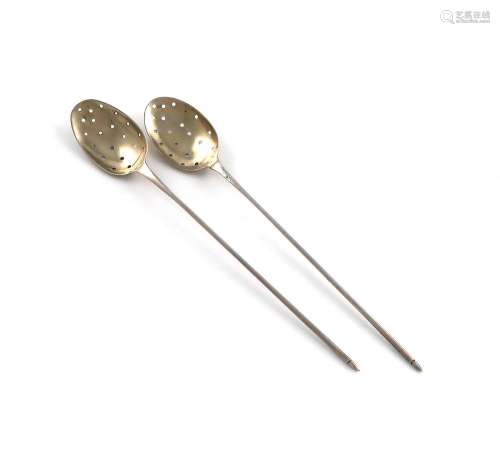 Two 18th century silver mote spoons, unmarked, the oval bowl...