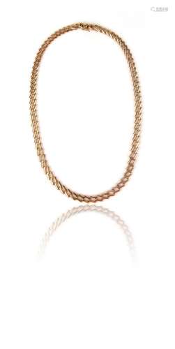 A gold chain necklace by Cartier, formed with oblique rectan...