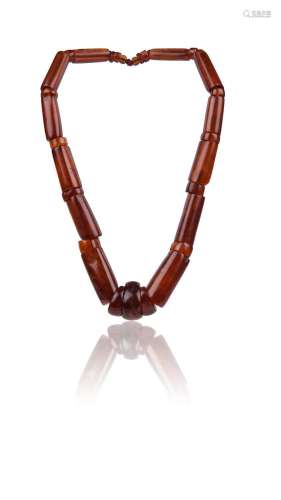 An amber bead necklace, composed of graduated cylindrical be...