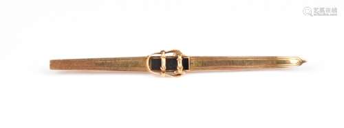 A Victorian gold novelty brooch, designed as a ski with blac...