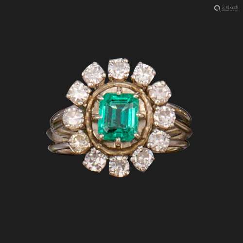 A French emerald and diamond cluster ring, the emerald-cut e...