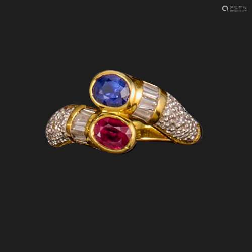 A ruby and sapphire crossover ring, rubover-set with an oval...