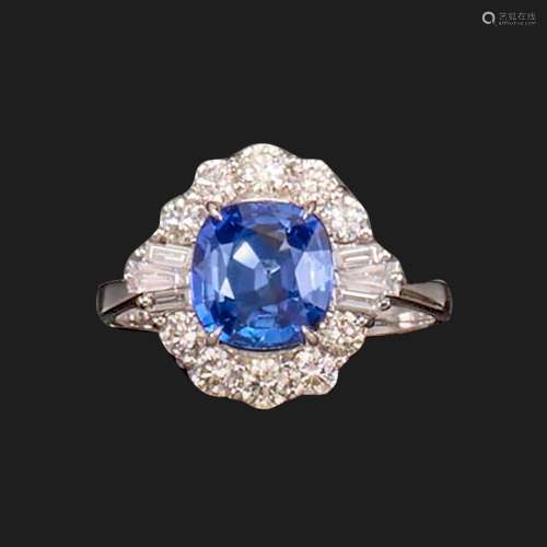 A sapphire and diamond ring, the cushion-shaped sapphire wei...
