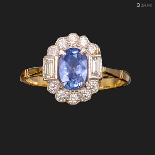 A sapphire and diamond cluster ring, the oval-shaped sapphir...