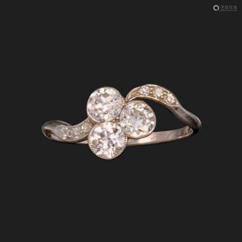A diamond three-stone ring, millegrain-set with a trefoil of...