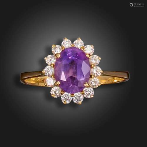 An amethyst and diamond cluster ring, the oval-shaped amethy...