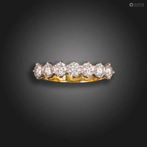 A diamond seven-stone ring, set with seven round brilliant-c...