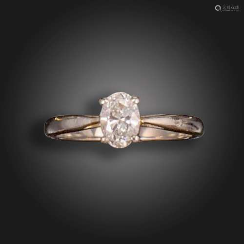 A diamond solitaire ring, the oval-shaped diamond weighs 0.5...