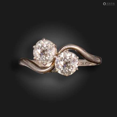 An early 20th century two-stone diamond crossover ring, set ...