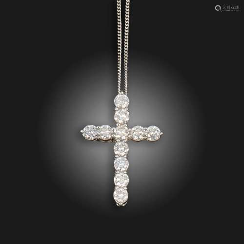 A diamond cruciform pendant, claw-set with round brilliant-c...