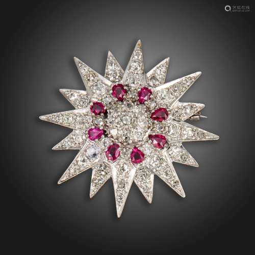 A diamond and ruby white gold star brooch, set overall with ...