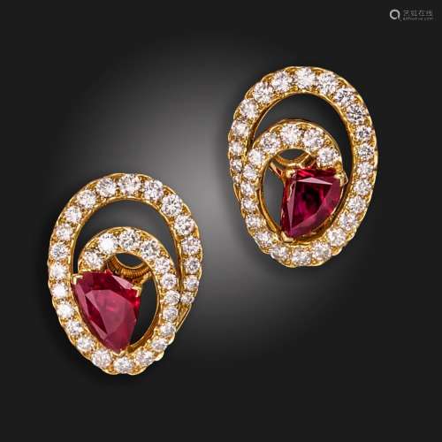 A pair of ruby and diamond ear clips, each of spiral design,...