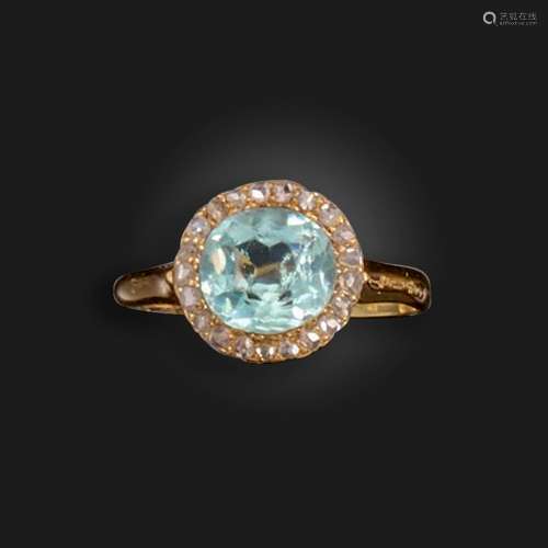 An Edwardian aquamarine and diamond cluster ring, the oval-s...