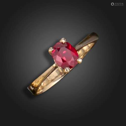 A ruby solitaire ring, claw-set with an oval ruby weighing 1...