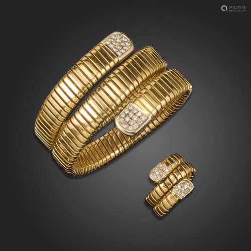 A gold bangle and ring, each formed with sprung and coiled b...