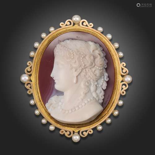 A late Victorian carved hardstone cameo mounted brooch, the ...