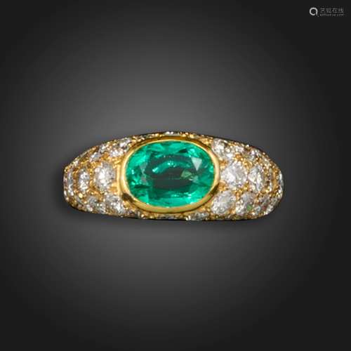 An emerald and diamond half hoop ring, set with an oval-shap...