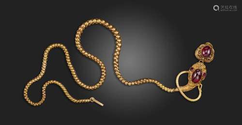 A Victorian garnet-set snake necklace, the serpents head set...