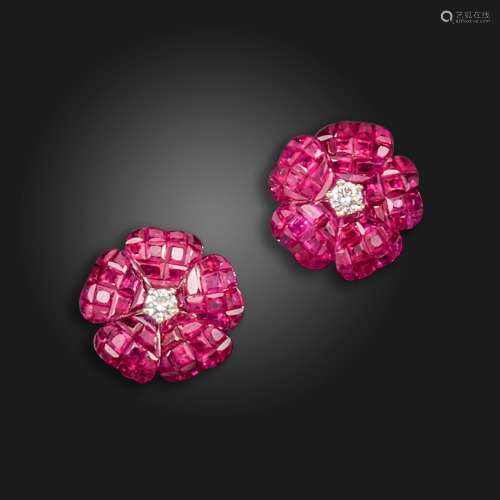 A pair of ruby flowerhead earrings, the petals invisibly-set...