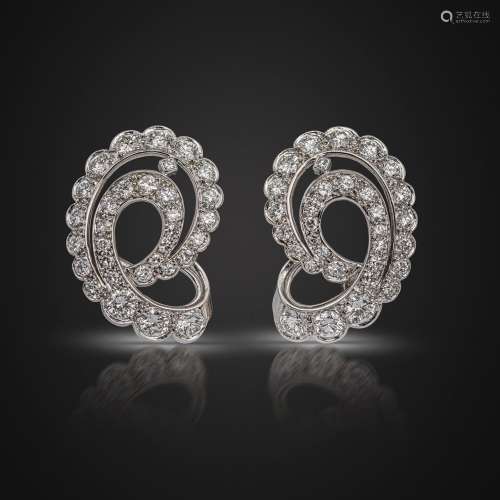A pair of diamond scroll earrings by Rene Boivin, set with g...
