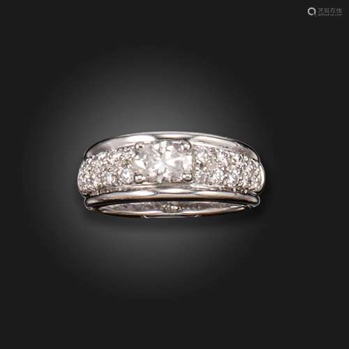 A diamond half hoop ring by Boucheron, set with an oval shap...