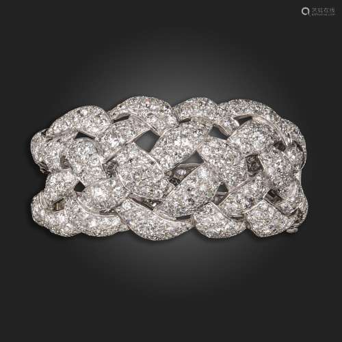 A diamond-set openwork platinum hinged bangle, the stylised ...