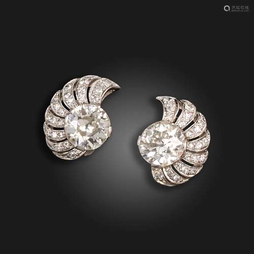 A pair of diamond scroll earrings, c.1940, each set with an ...