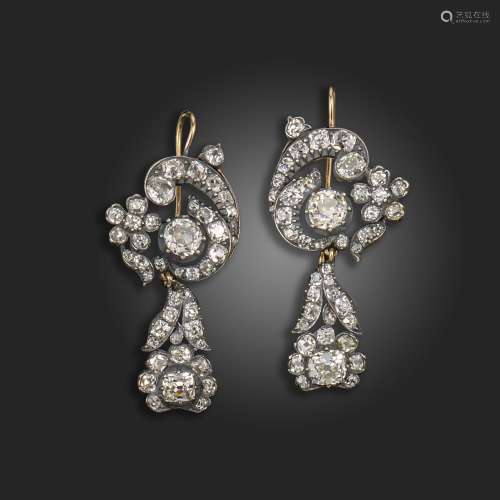 A pair of late 19th century diamond drop earrings, of scroll...