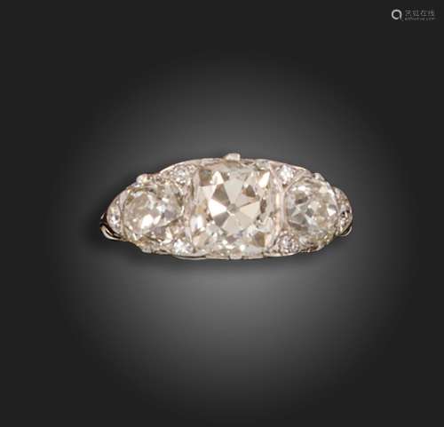 A diamond three-stone ring, set with an old cushion-shaped d...