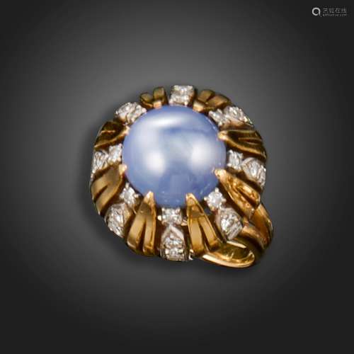 A star sapphire and diamond ring, set with a circular star s...