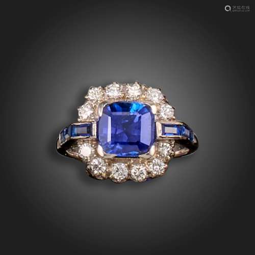A sapphire and diamond cluster ring, the square cushion-shap...