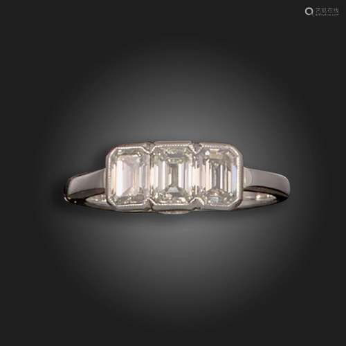 A diamond three-stone ring, set with three emerald-cut diamo...