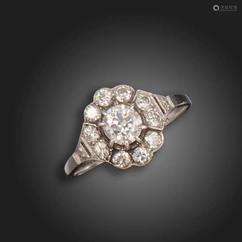 A diamond cluster ring, set with a transitional round brilli...