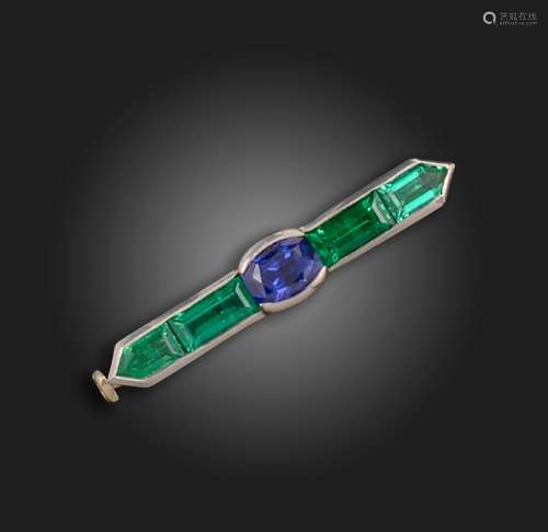 A gem-set bar brooch, centred with an oval-shaped sapphire b...