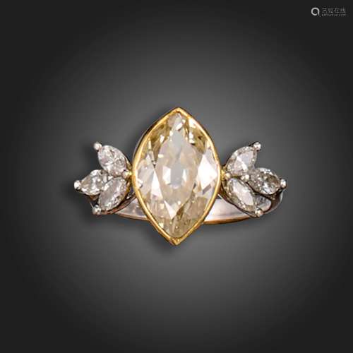 A diamond cluster ring, the marquise-shaped diamond weighs a...
