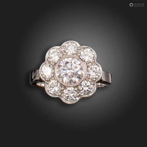 A diamond cluster ring, the centre round brilliant-cut diamo...