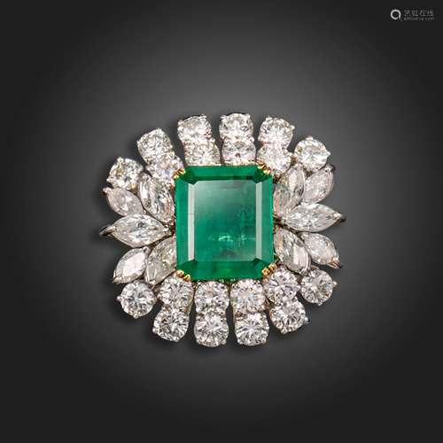 An emerald and diamond cluster ring, the emerald-cut emerald...