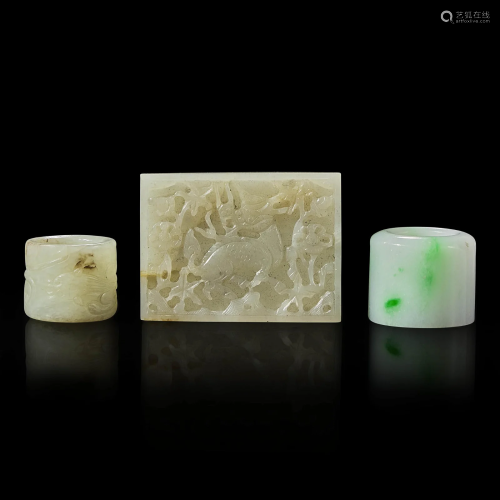 Two Chinese jade and jadeite thumb rings and a carved jade b...