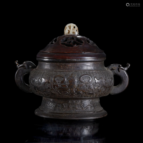 A Chinese patinated bronze vessel with wood cover and jade f...
