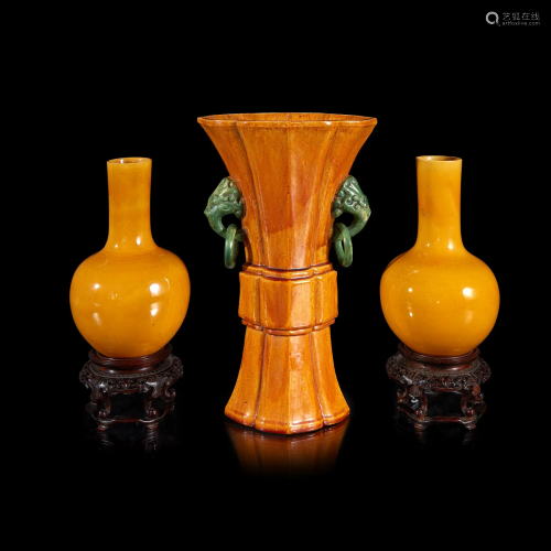 A pair of Chinese yellow-glazed bottle vases and a yellow-gl...