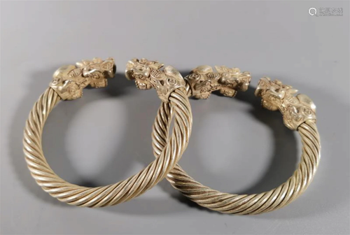 A Pair of Carved Silver Bracelets