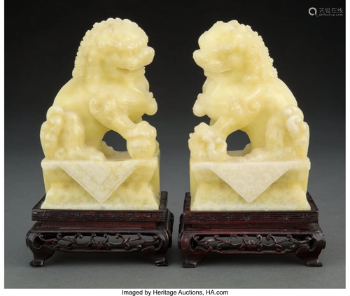 A Pair of Chinese Carved Hardstone Lions on Stan