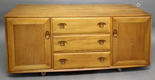 ERCOL SIDEBOARD Model No 455, a light elm sideboard with thr...