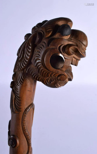 AN EARLY 20TH CENTURY SOUTH EAST ASIAN CARVED WOOD DRAGON WA...