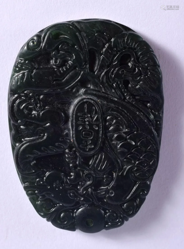 A CHINESE DARK GREEN JADE DRAGON PENDANT 20th Century. 4.5 c...