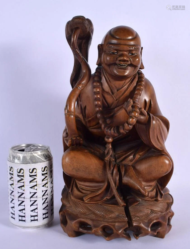 A 19TH CENTURY CHINESE CARVED ROOTWOOD FIGURE OF A BUDDHA mo...